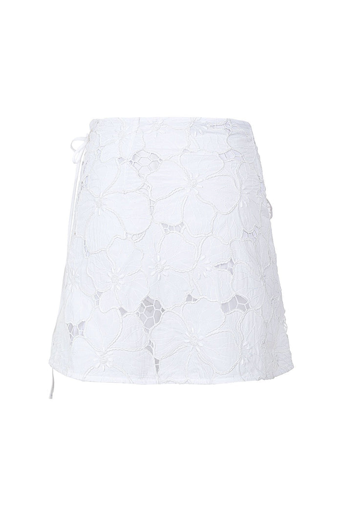 White mini skirt with floral lace embroidery, featuring side tie closure