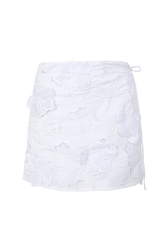 White mini skirt with raised floral embroidery, side tie closures