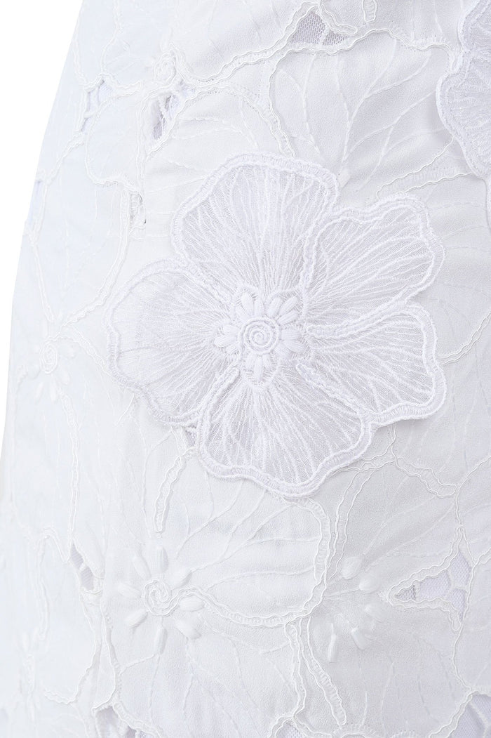 White mini skirt with floral embroidery detailing and wrap closure