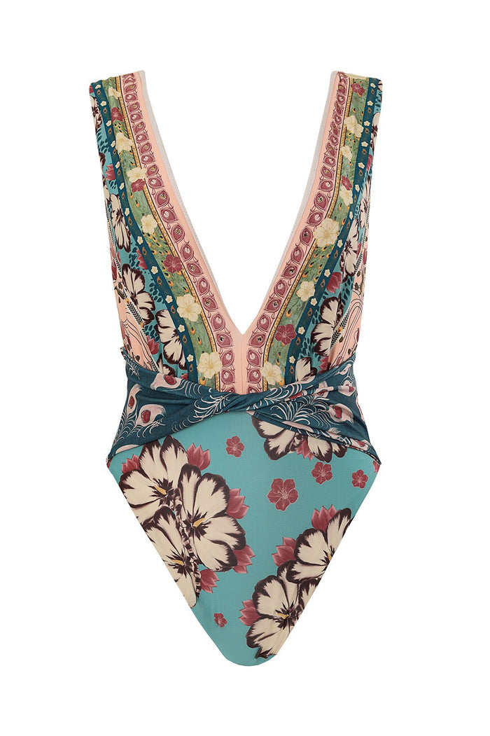 Teal one piece swimsuit with mixed pattern detail and geometric striped print, deep V neckline with decorative trim, and twisted knot detail at waist