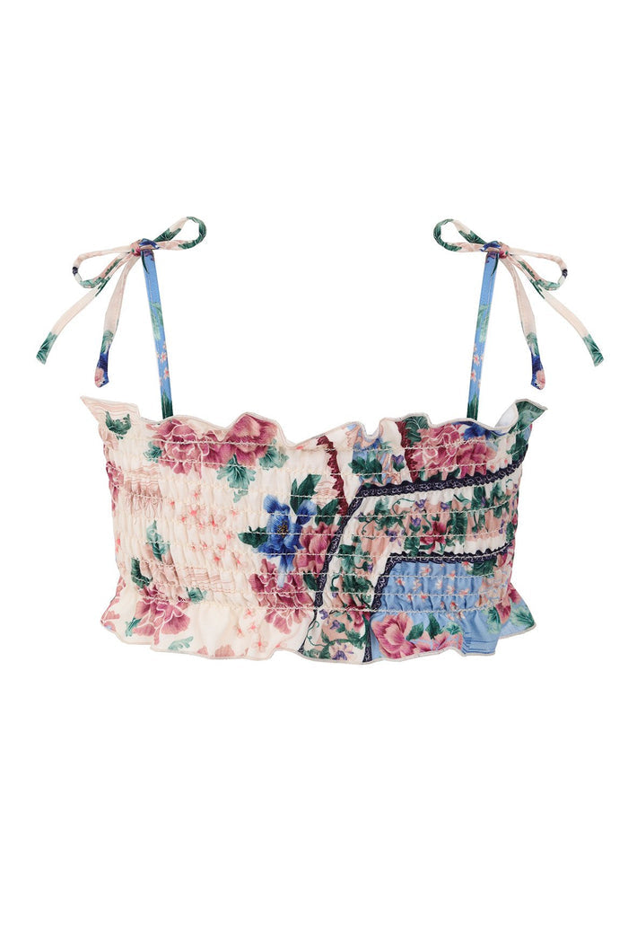Smocked bikini top with tie straps in multicolor pattern detail print featuring pink blooms and green foliage on cream and blue color-blocked fabric