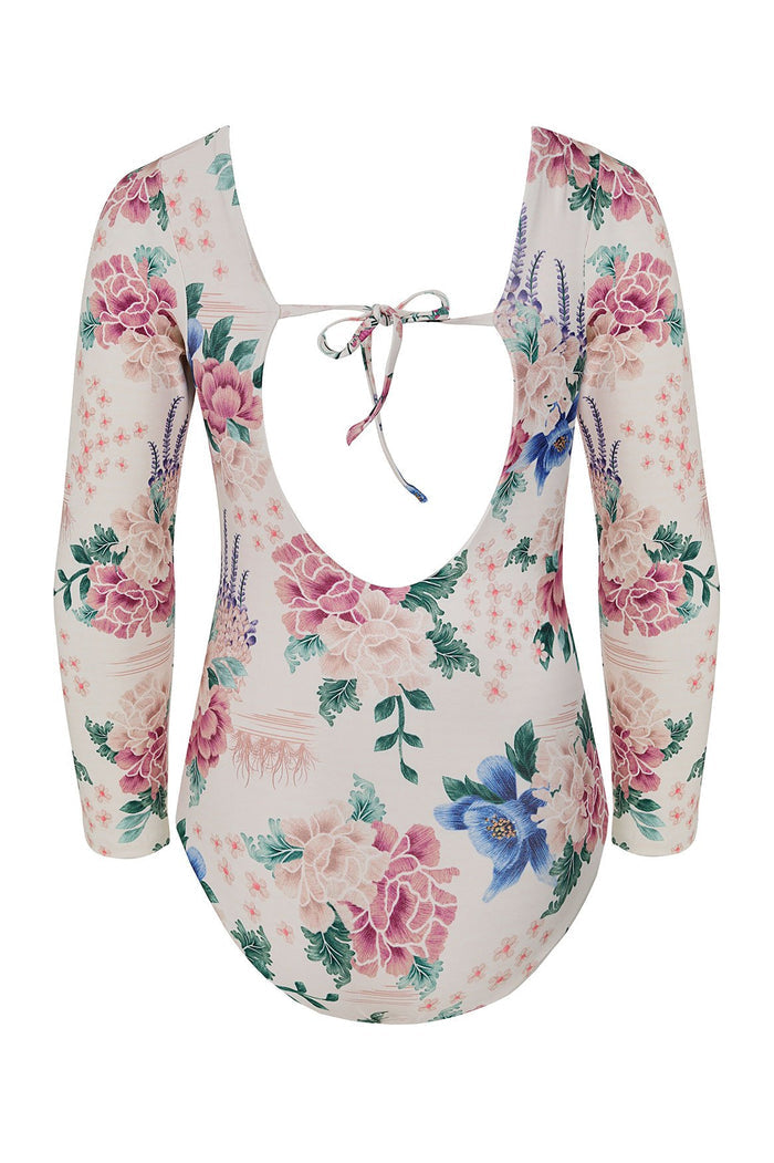 Nader Honey long sleeve one piece swimsuit in cream with pattern detail print featuring pink and peach peonies, blue flowers, green leaves, and laven…