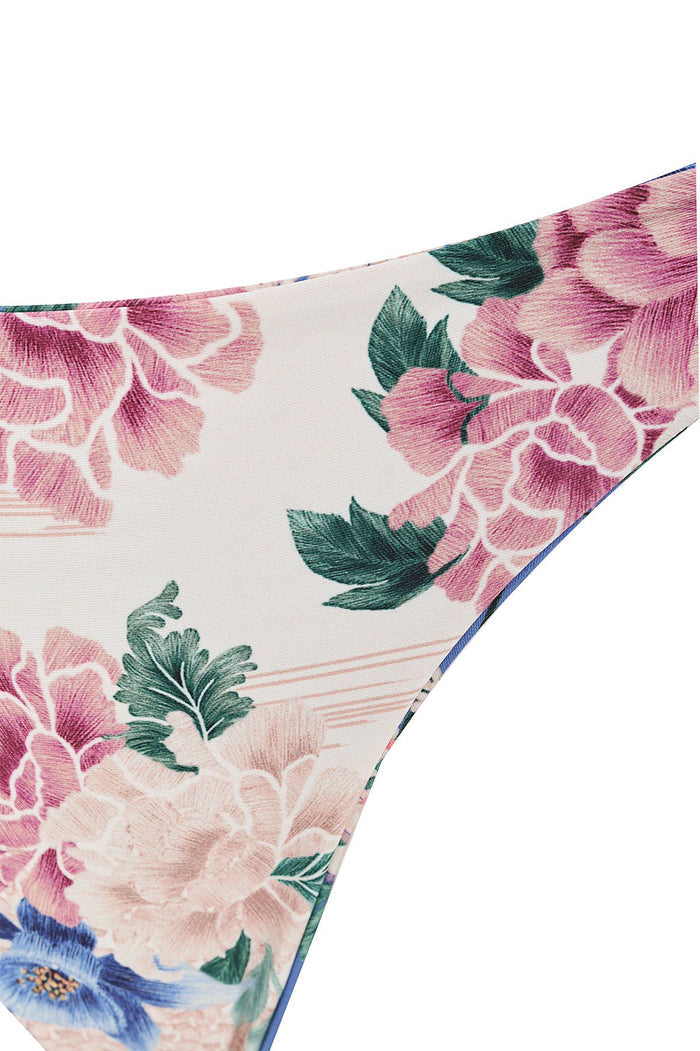 Nader Ilu bikini bottom with pink and cream pattern detail print and green foliage on ivory background, blue trim