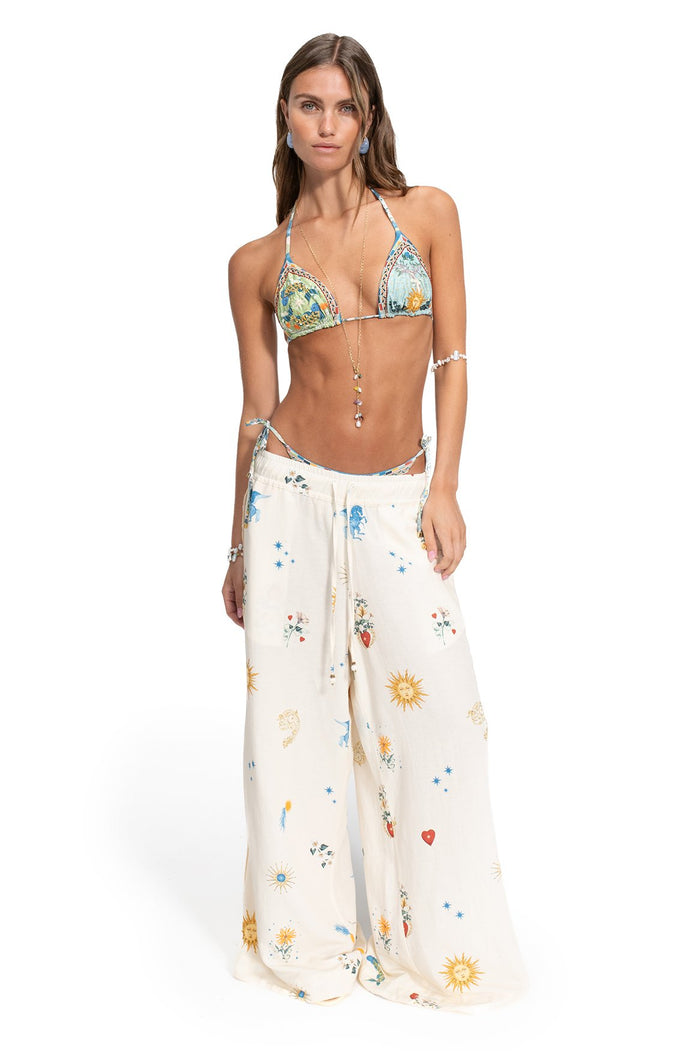 Nader Janis wide-leg pants in cream with celestial print of suns, stars, and scattered florals