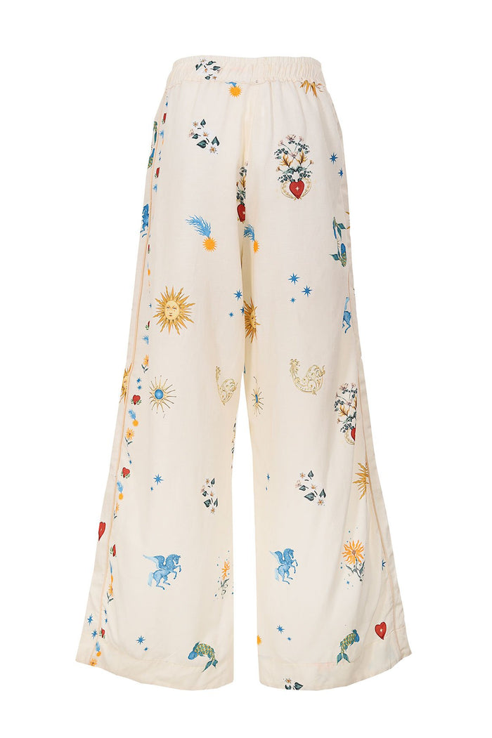 Nader Janis wide-leg pants in cream with scattered celestial print featuring suns, stars, hearts, and pattern detail details