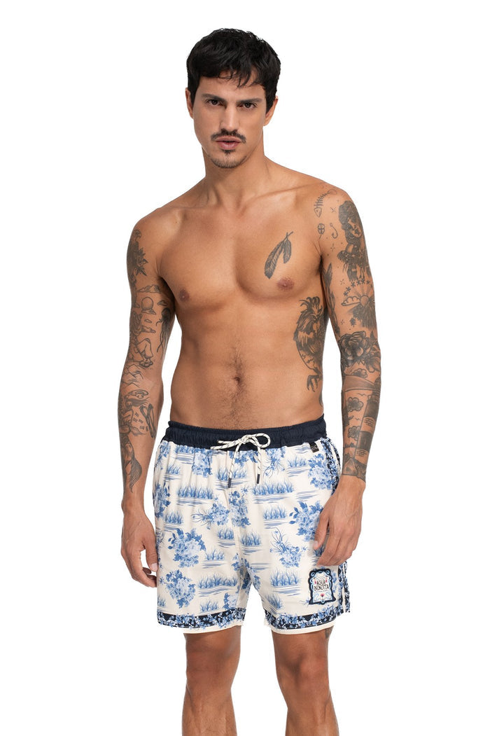 Nader Joe Men's Swim Trunks in cream with blue toile print featuring nautical scenes and contrast patterned hem trim