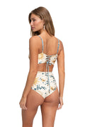 High-waist bikini bottom in cream with botanical print of golden leaves and teal eucalyptus branches, back view with cut-out detail and reversible bl…