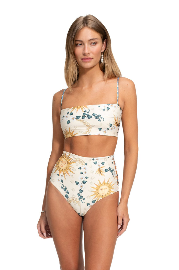 High-waist bikini bottom in cream with sun face and botanical vine print, paired with matching bandeau top