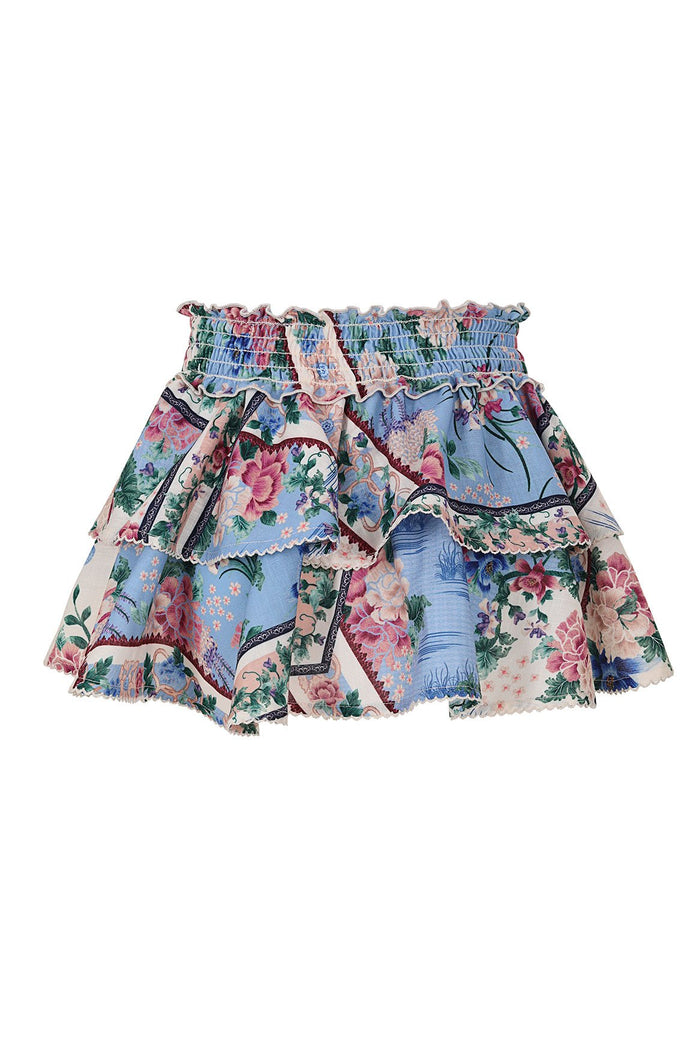 Nader Kavi kids' skirt with smocked elastic waist, tiered ruffle layers, and multicolor pattern detail print on blue and pink patchwork panels