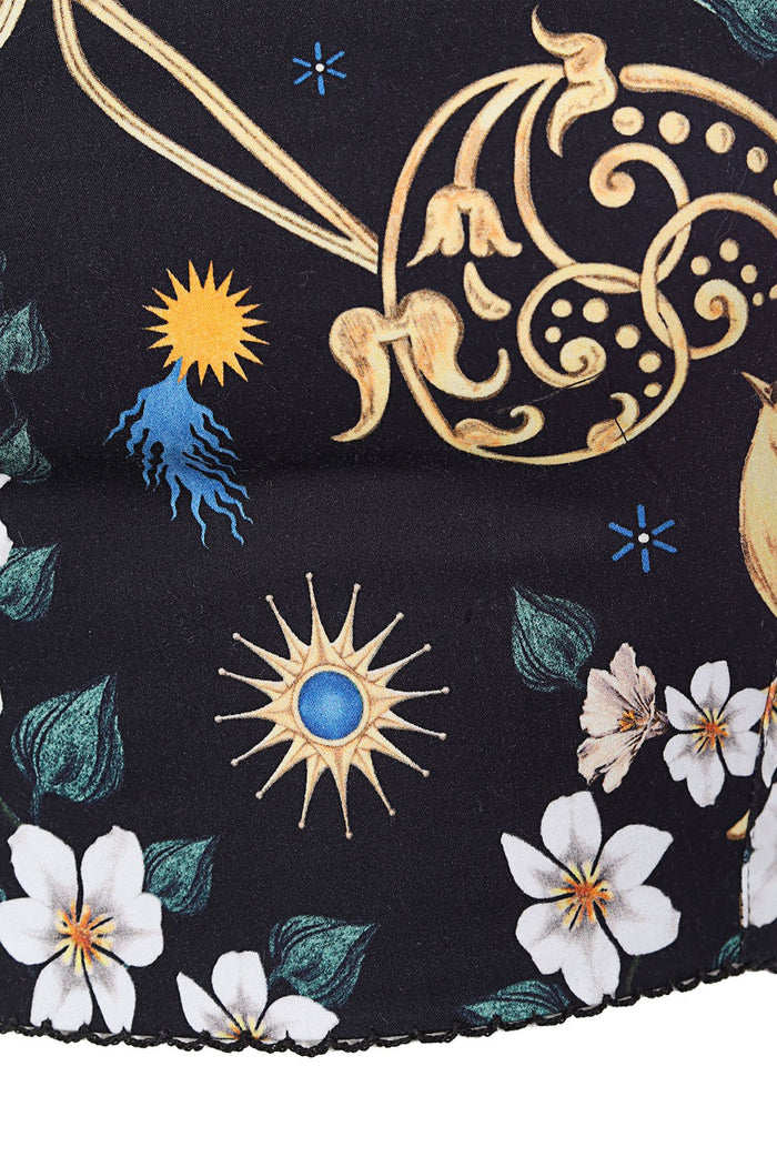 Black crop top with sun emblems, white flowers, teal leaves, and gold scrollwork embroidery