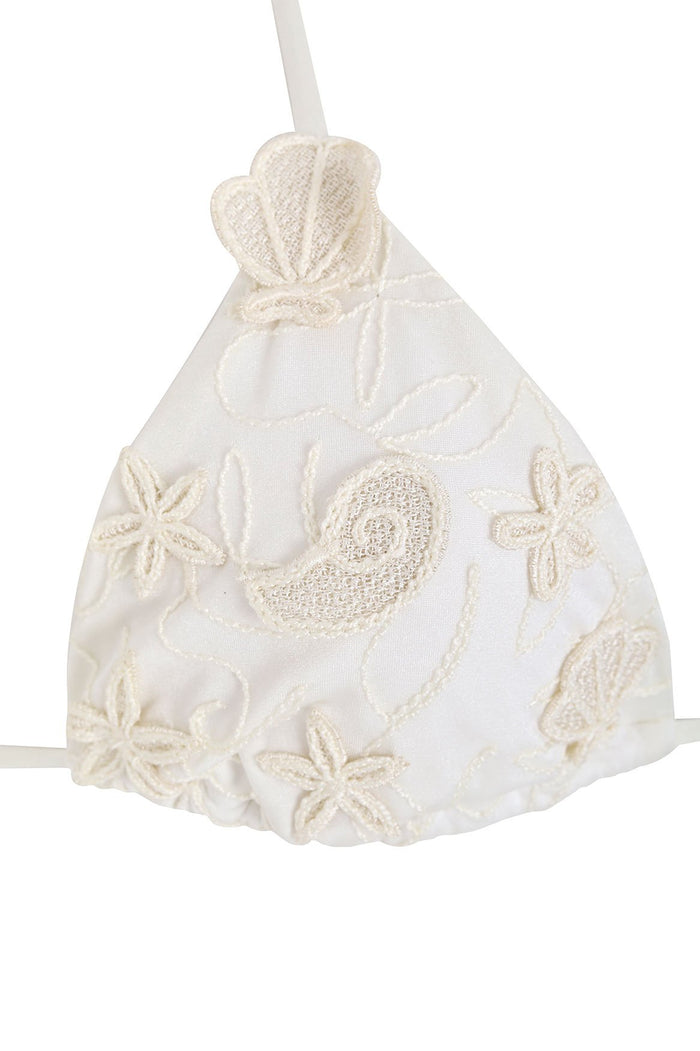 White triangle bikini top with textured 3D embroidery of seashells and flowers, scalloped hem, and decorative halter tie