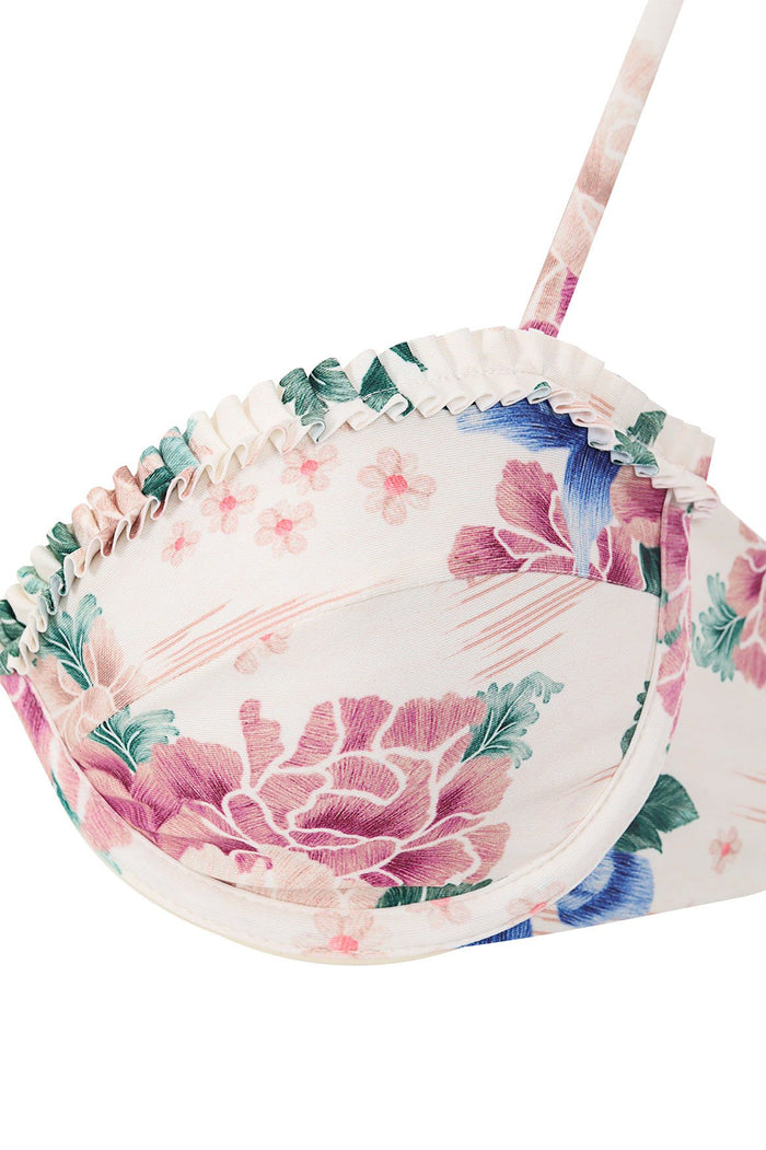 Nader Madelyn bikini top in ivory with pink and blue floral print, ruffled trim, and adjustable straps with matching tie-ends