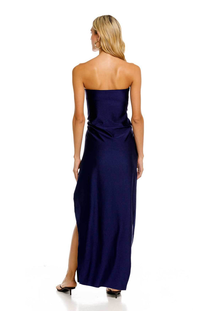 Navy blue strapless maxi dress with side slit and decorative marble-like stone detail at hip, back view