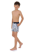 Boys' swim trunks in white with blue decorative print and contrasting navy waistband
