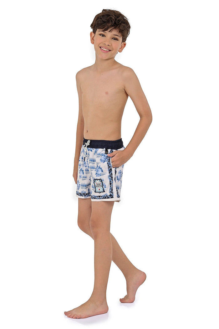 Boys' swim trunks in white with blue decorative print and contrasting navy waistband