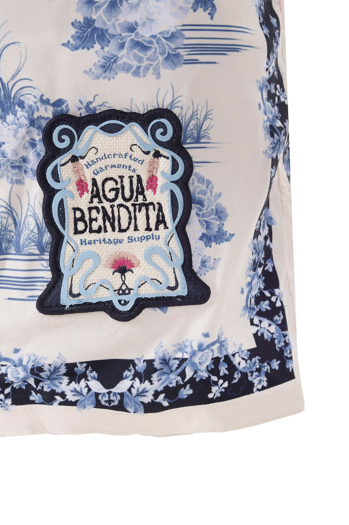 Boys' swim trunks in cream with blue toile print and embroidered brand emblem at front
