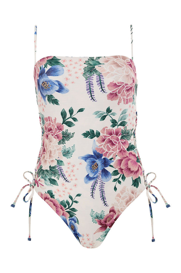 One-piece swimsuit in white with pink, blue and coral floral print, straight neckline, adjustable side ties with handmade tie-ends