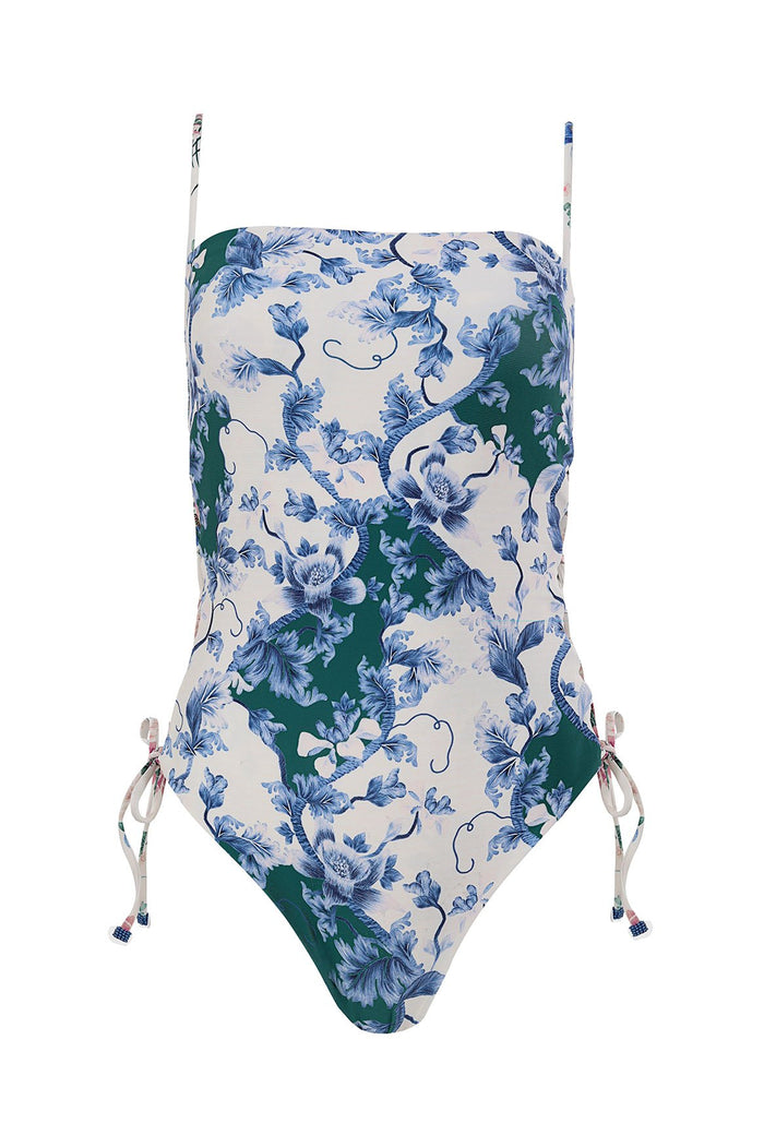 One-piece swimsuit with straight neckline, adjustable side ties, and blue floral print on cream and teal background