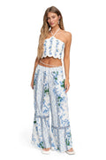 White halter crop top with scalloped hem and blue pattern detail embroidery in vertical stripes, paired with matching wide-leg pants