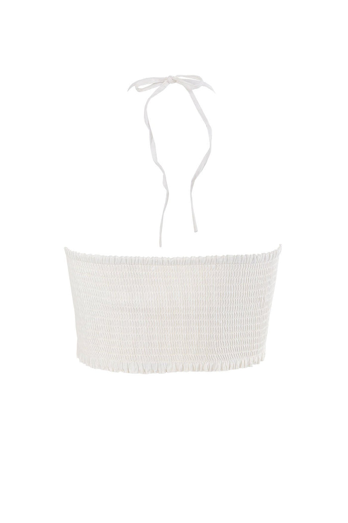 White halter crop top with smocked body and tie-back closure