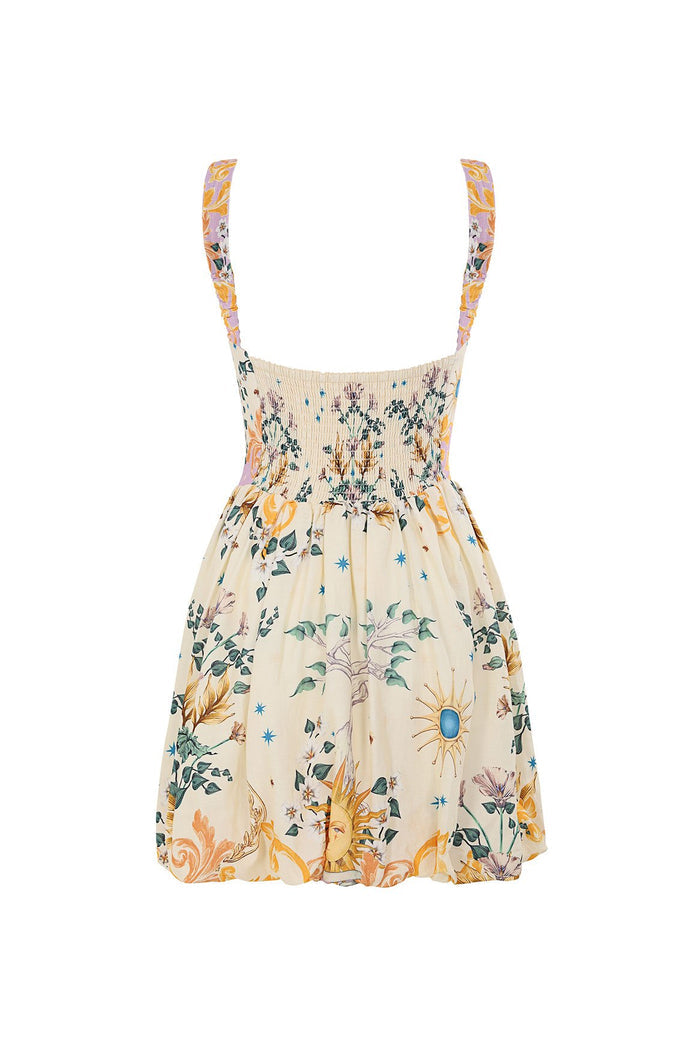 Nader Stella mini dress in cream with smocked bodice, pattern detail print featuring sun motifs in yellow, green, and pink tones