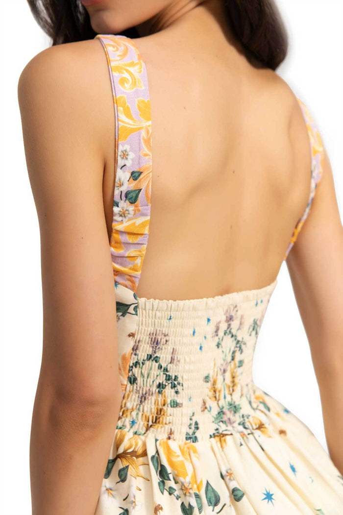 Nader Stella Dress back view with smocked detail, cream base with yellow swirl panel print on straps and multicolor pattern detail print on skirt