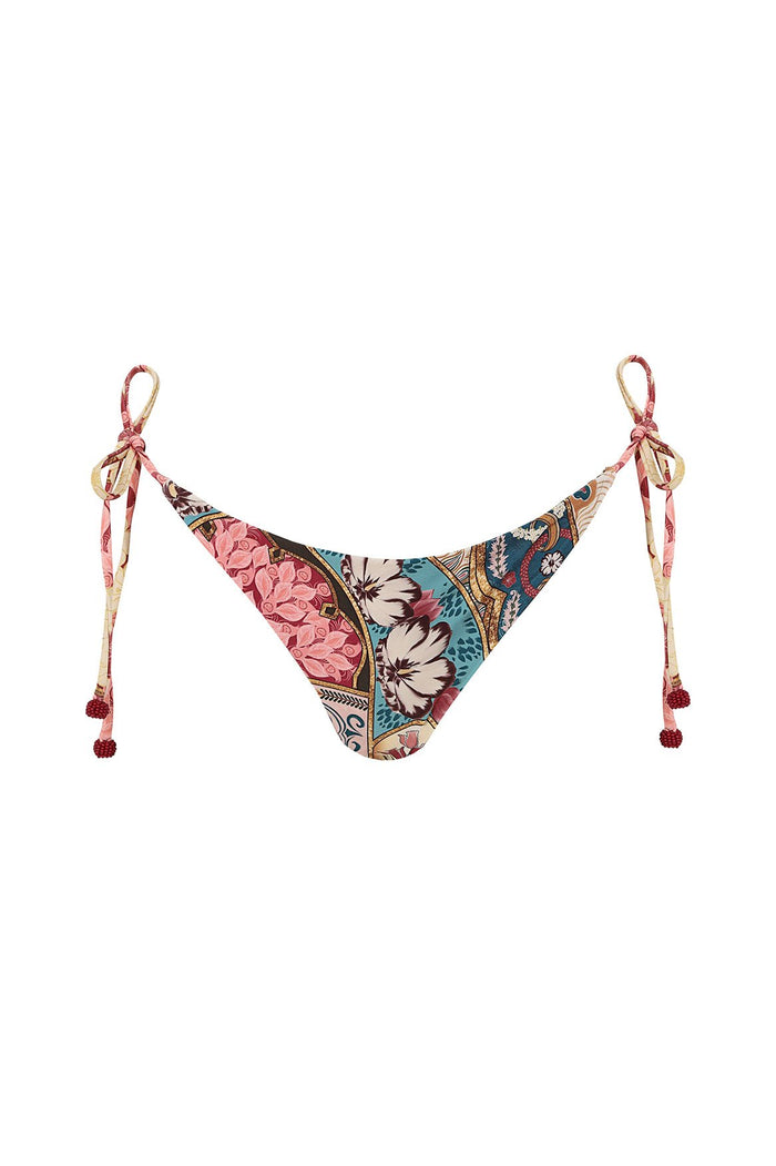 Nader Tammy bikini bottom with side ties and handmade beaded tie-ends, featuring placement print with pink pattern detail blooms, turquoise and cream…
