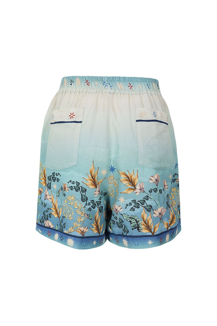 Nader Watts Shorts in cream and blue gradient with botanical print of leaves and star accents, elastic waistband and functional pockets