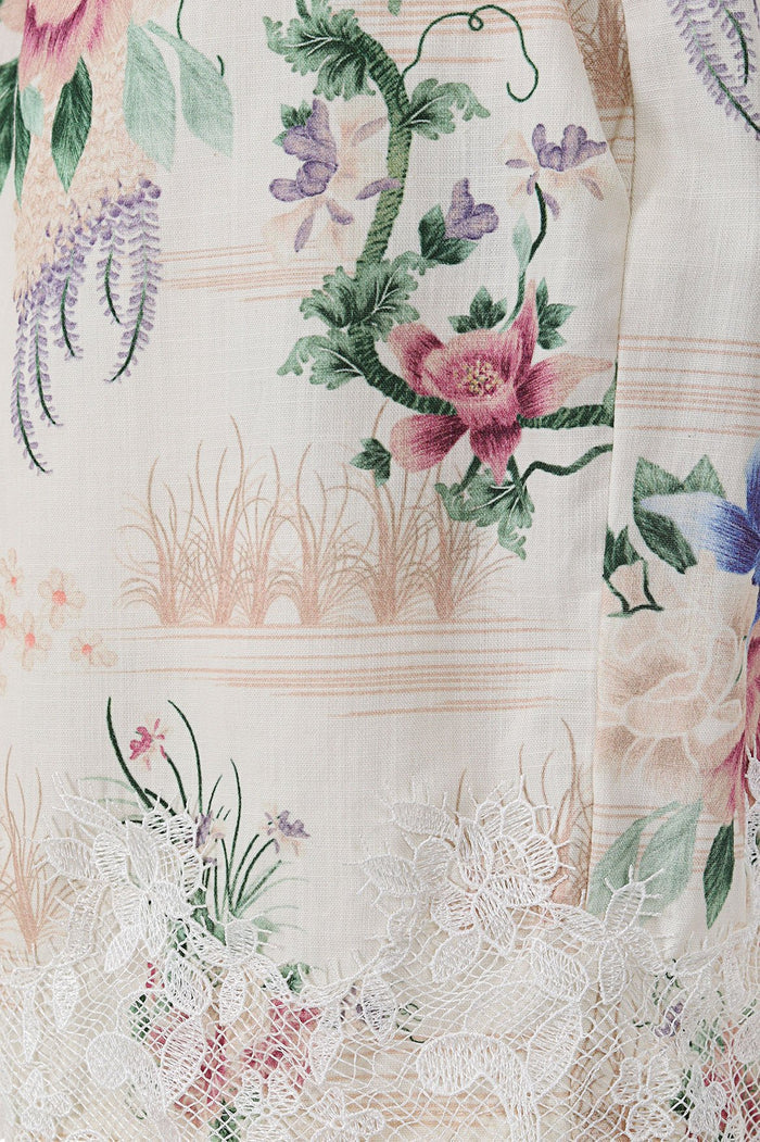 Nader Watts Shorts in cream with watercolor floral print featuring pink, purple and green botanicals and white lace trim at hem