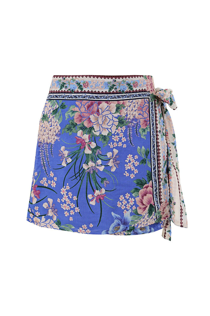Nader Ziara wrap skirt in periwinkle blue with cascading floral print featuring wisteria, peonies and small blossoms, side tie closure and contrast b…