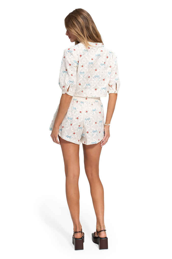 White eyelet shorts and top set with scattered blue and coral pattern detail print, back view showing elastic waist and relaxed fit