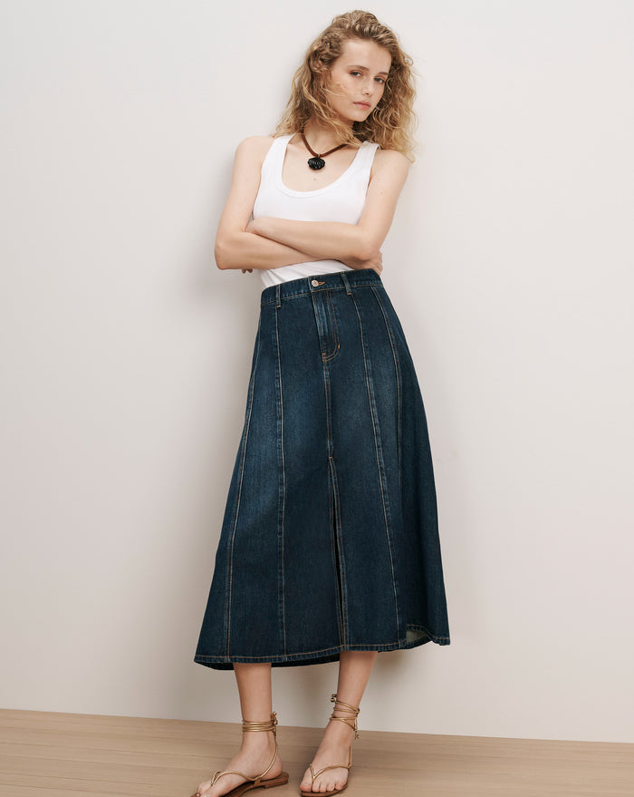 Veronica Beard White tank top, dark wash denim midi skirt.