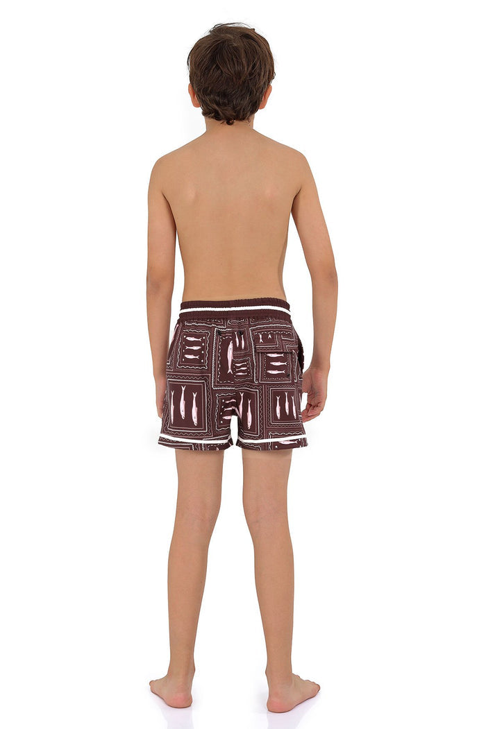 Brown swim trunks with geometric block print pattern in white and pink, featuring white contrast waistband trim