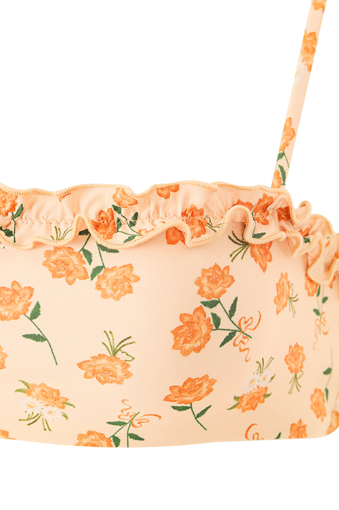 Peach bikini top with ruched edge detail and pattern detail print featuring orange blooms and green leaves