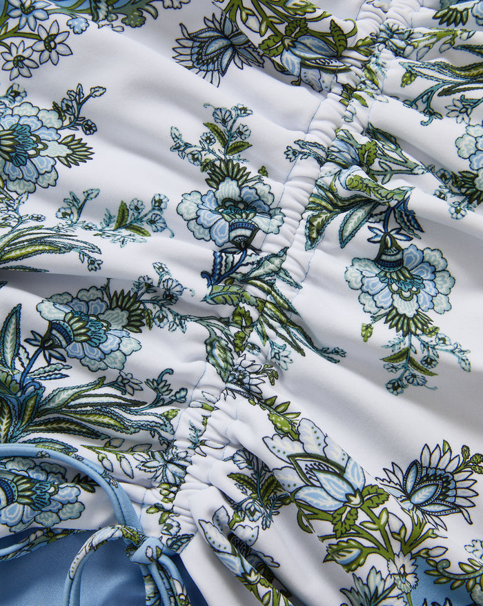 Veronica Beard White ruched swimsuit with blue and green floral print.
