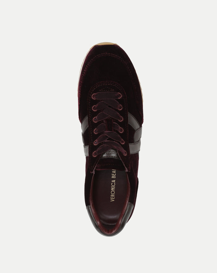 Veronica Beard Burgundy velvet sneaker with dark leather stripes.