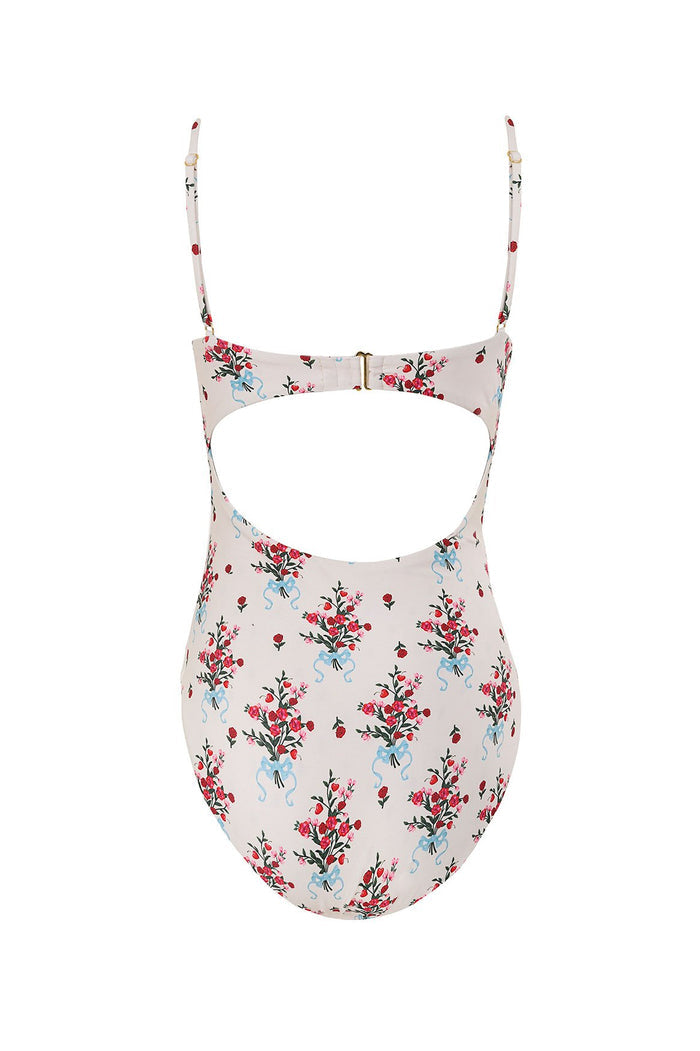 Petra one piece swimsuit in pale pink with pattern detail print featuring red and pink blooms with blue ribbon details and underwire bust with front…