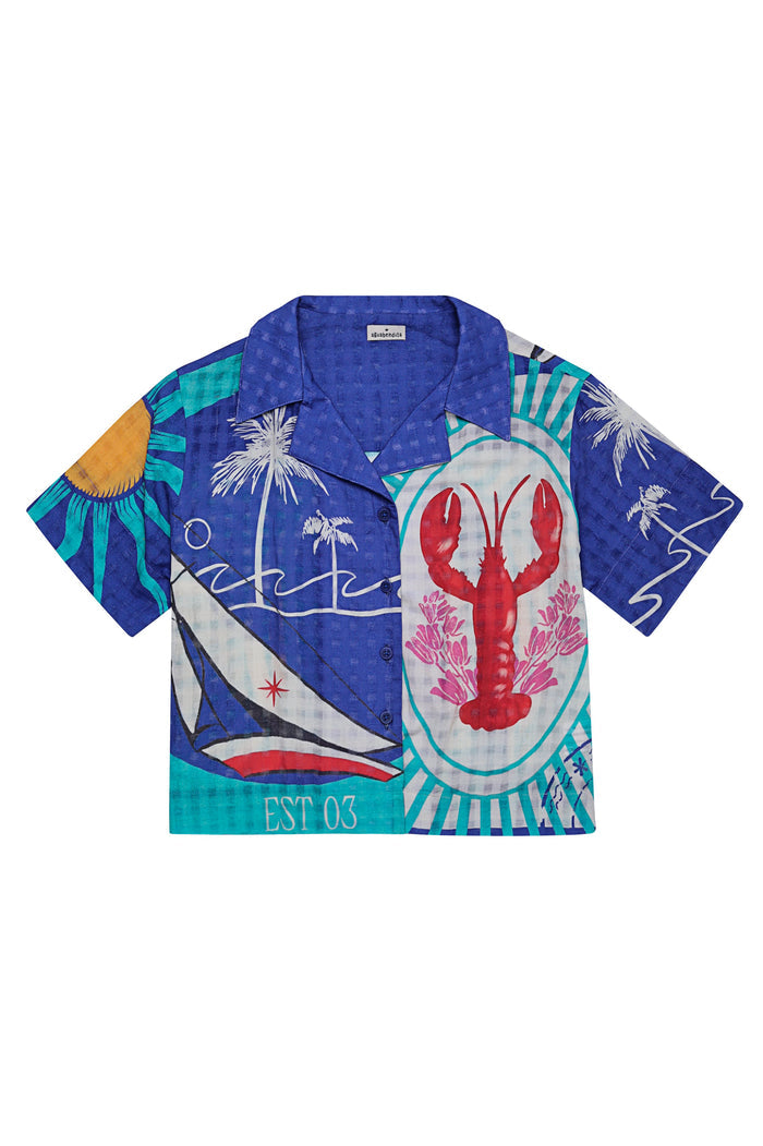 Blue short-sleeve button-up shirt with placement print featuring red lobster, white palm trees, sailboat, and turquoise geometric patterns