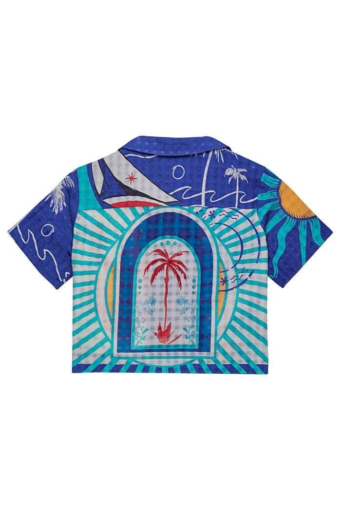 Short-sleeve button-up shirt in royal blue with placement print featuring central archway framed by turquoise and white diagonal stripes, red palm tr…