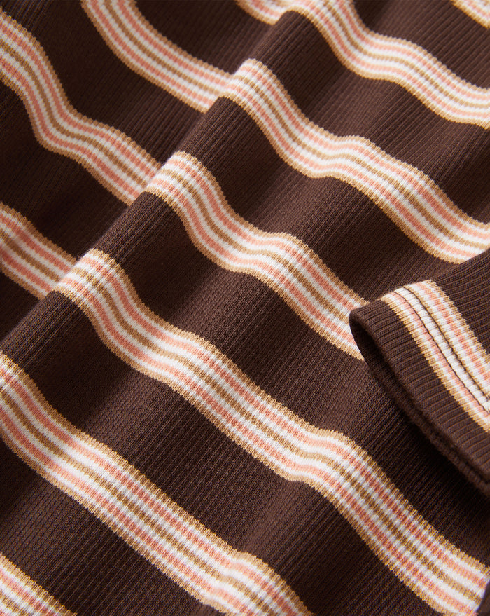 Veronica Beard Brown and pink striped knit t-shirt with light wash wide-leg jeans.