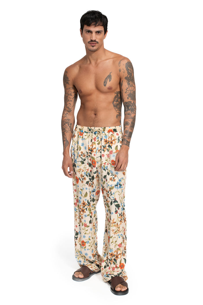 Rene Pants in cream with allover floral print featuring orange, blue, and green blooms with foliage, relaxed fit with elastic waistband