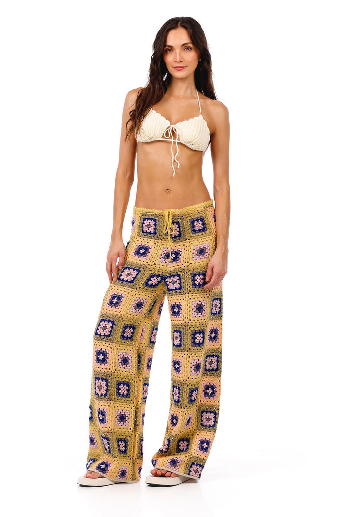 Wide-leg crochet pants in yellow with granny square pattern featuring pink, blue, and green pattern detail centers