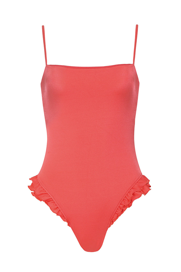 Coral one-piece swimsuit with straight neckline, thin adjustable straps, and ruffle detail along leg openings