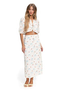 White cropped top with puff sleeves, tie-front closure, and scattered blue and coral pattern detail print on eyelet fabric with scalloped trim