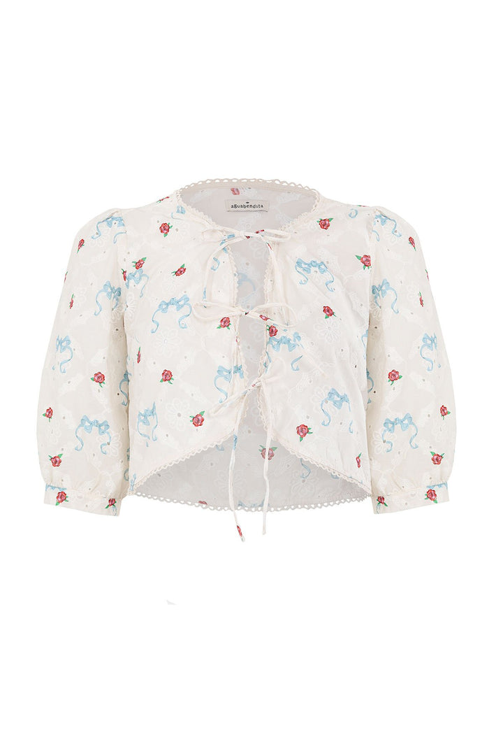 White eyelet crop top with blue ribbon and red rose print, tie-bow front closure and scalloped trim