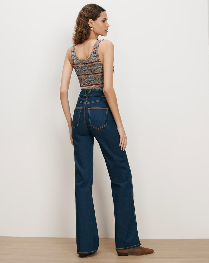 Veronica Beard Dark wash flare jeans and a striped knit tank top.
