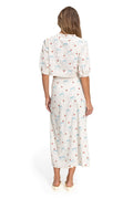 Sarahi Maxi Skirt in ivory eyelet fabric with blue and coral pattern detail print, puff-sleeve cropped top, trim details, and side button closures, b…