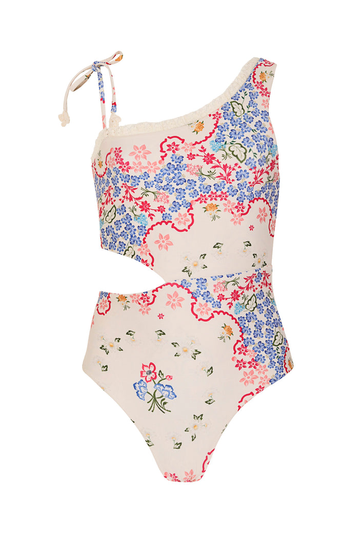 Savana asymmetric one-piece swimsuit with cutout detail in cream featuring scattered pattern detail print in blue, pink, and red with crochet trim