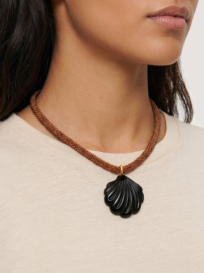 Veronica Beard Brown beaded necklace with a dark shell pendant.