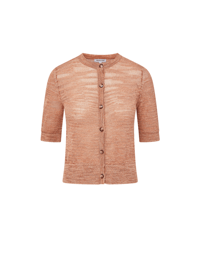 Veronica Beard Coral textured knit cardigan with short sleeves and light wash denim shorts.
